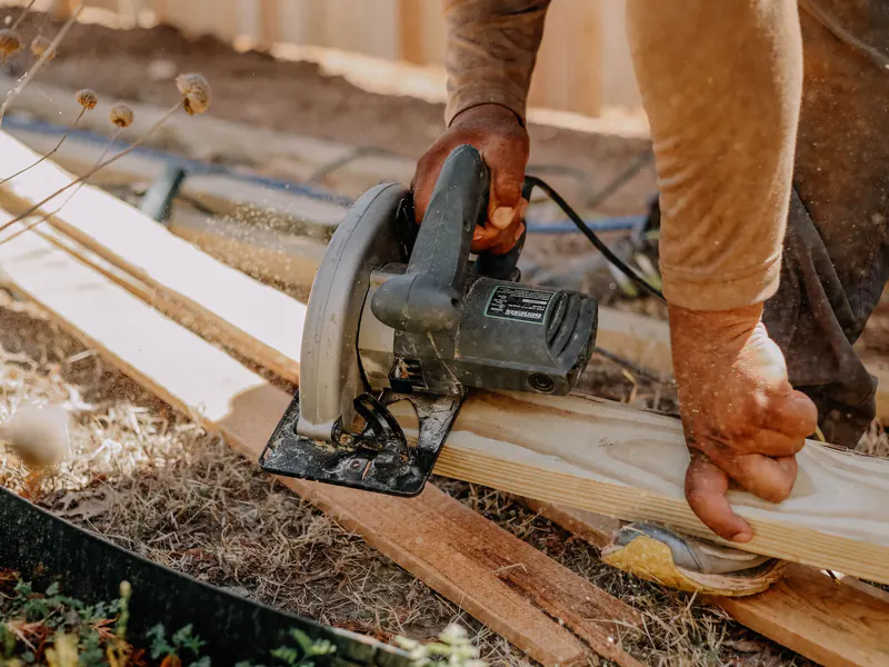 A circular saw cutting new boards