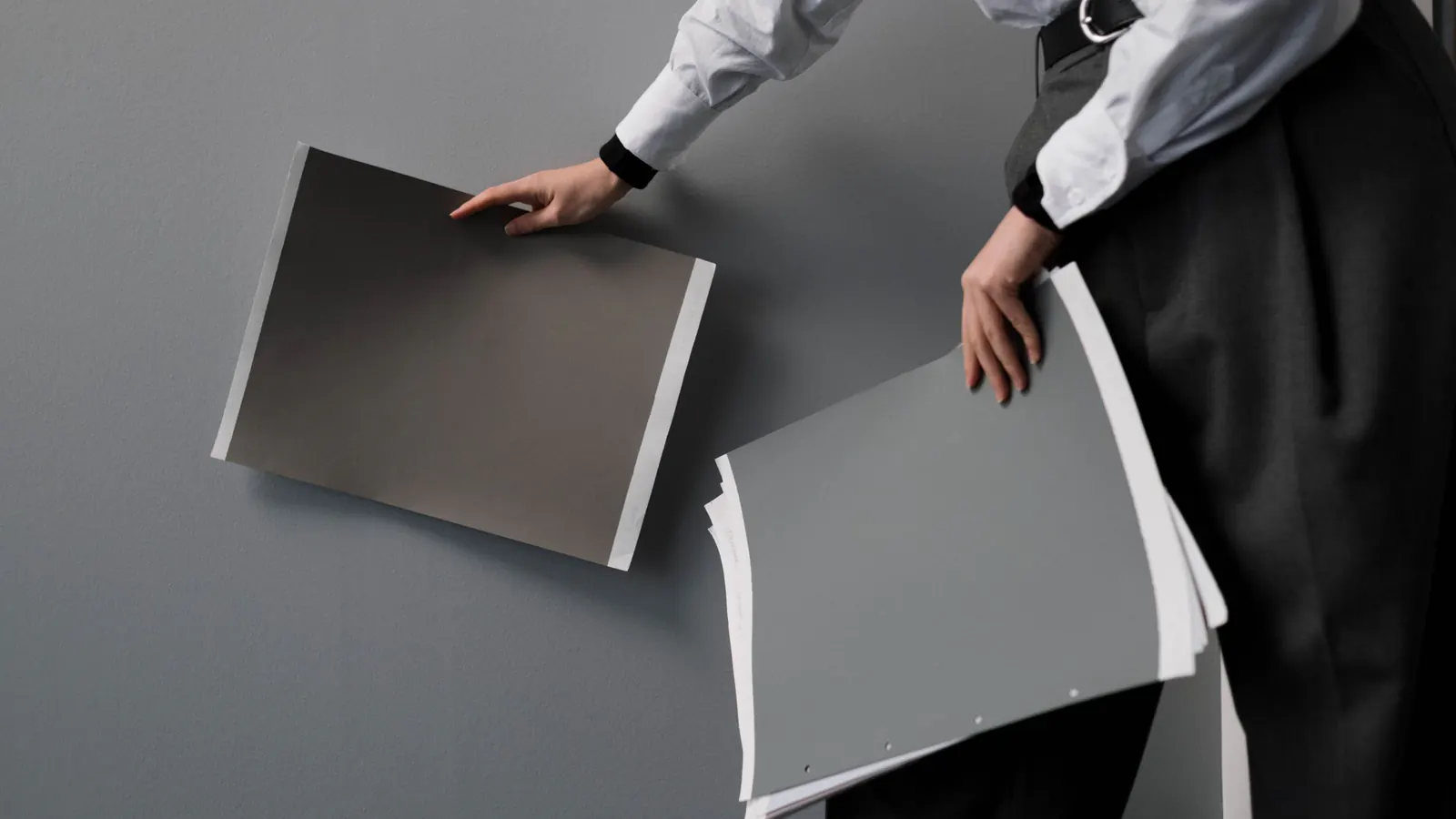 Two large gray sample boards held up to a wall