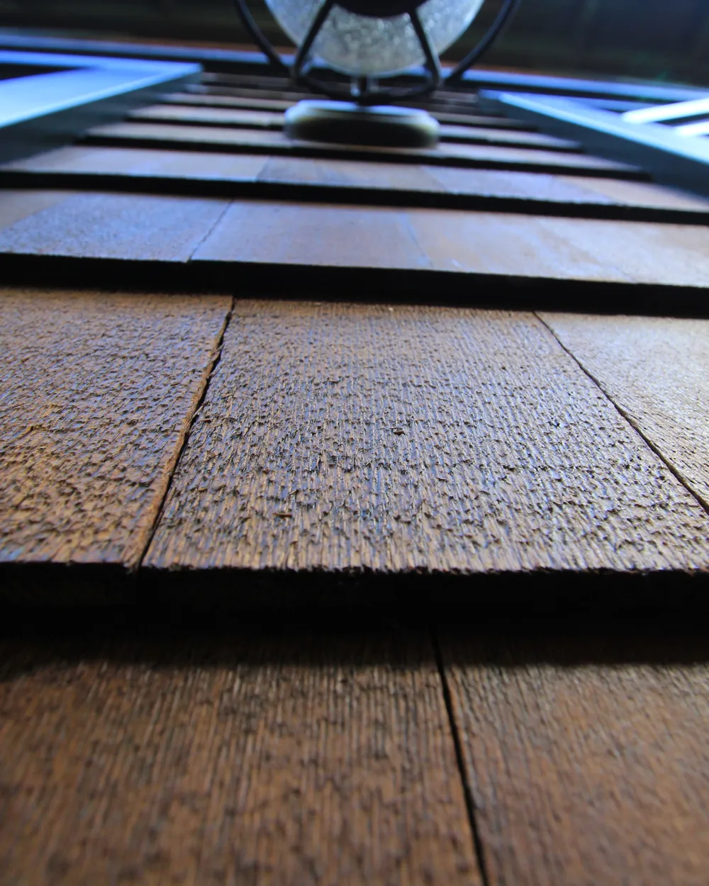 Looking up at a shingled eave from below, its boards and trim in close detail
