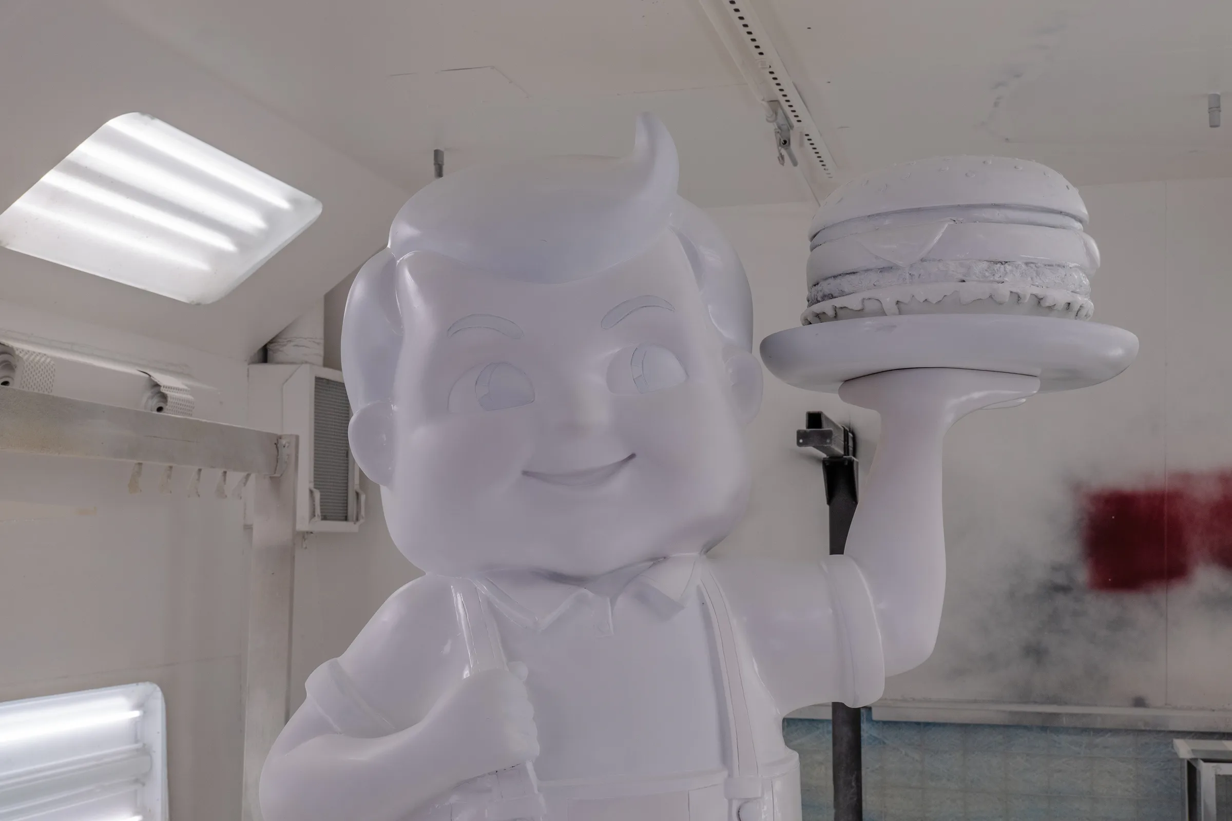 The Big Boy statue fully primed white in the spray booth, before any colour goes on